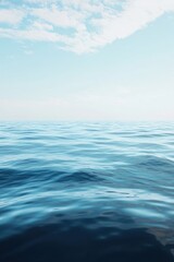 A tranquil ocean scene with a gentle breeze creating ripples on the surface, against a clear sky