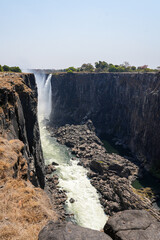 Chasm of the victoria falls water falls with water flowing through it in September in Zimbabwe 