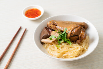 dried noodles with braised duck in white bowl