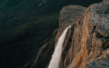 Powerful Waterfall Cascading Down Rocky Cliff
