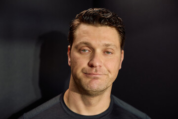 Studio shot of uninterested man looking at camera.