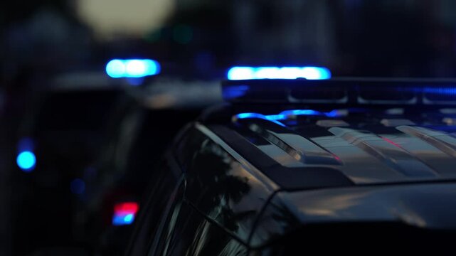 Police car lights flashing. Crime scene at night. Patrol vehicle outdoors. Emergency lights glowing. Flashing police siren. Police car vehicle. Law enforcement. City night patrol. Police arrest.