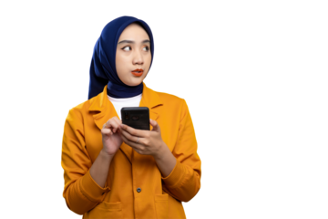 Amazed young Asian woman using smartphone and looking at copy space, checking online offers isolated on transparent background
