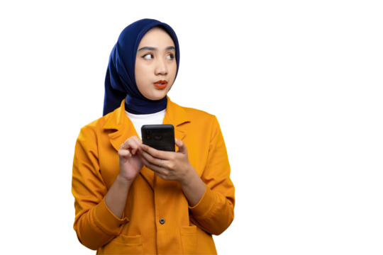 Amazed young Asian woman using smartphone and looking at copy space, checking online offers isolated on transparent background