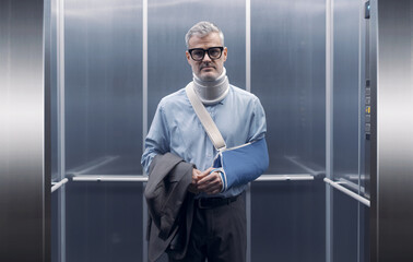 Man with broken arm standing in the elevator