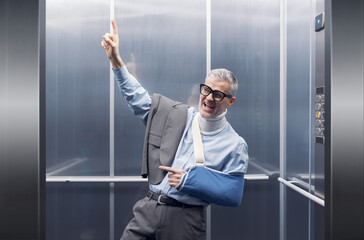 Cheerful man faking an injury and deceiving an insurance company