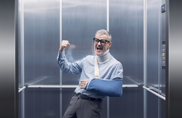 Cheerful man faking an injury and deceiving an insurance company
