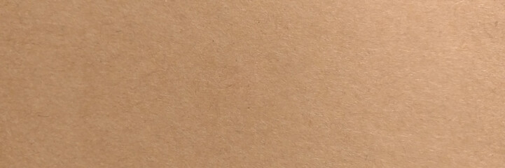 Brown cardboard sheet of paper background. Close up brown paper texture and background with copy space. 