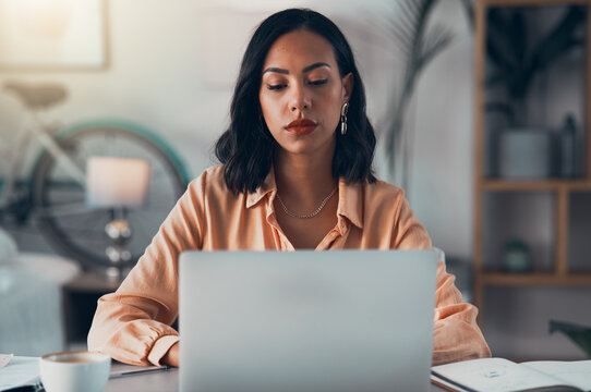 Elegant, professional and freelance worker on her laptop inside home office. Formal, stylish and fashionable corporate employee online. Remote, communication and sending emails in digital workplace.