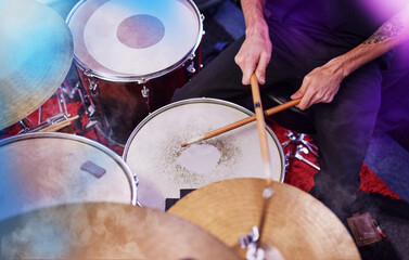Drummer, rock and man hands at music festival, show and playing electric instrument for band. Sound...