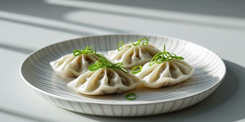 Pan Fried Dumplings with Green Onions on Striped Plate