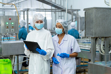 Canned food manufacturing factory industry. Quality control officer inspecting production line....