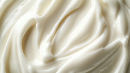 A close-up of smooth, white cream with swirling patterns.