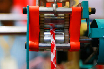Close-up of the mechanism of a spinning machine in a textile factory