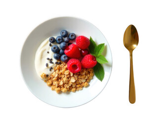 Bowl of yogurt with blueberries, raspberries, granola,  mint leaves served on a white plate next to a gold spoon, concept of luxury breakfast, healthy food campaign, wellness visuals