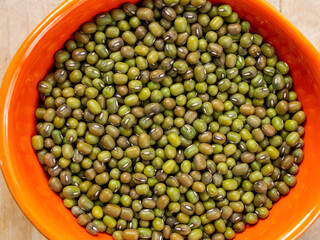Mung beans on a light background, emphasizing their shape and texture, create a feeling of freshness and naturalness.