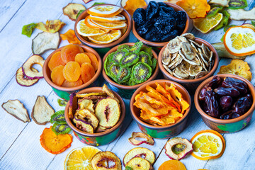 Organic Healthy Assorted Dried Fruit Mix close up. Dried fruit snacks. dried apples, mango, feijoa, dried apricots, prunes top view