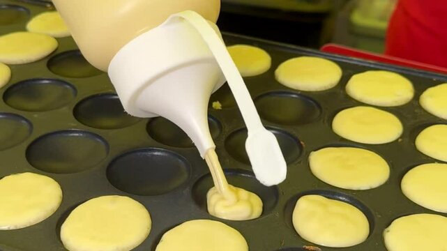 Mini Pancake Batter Being Poured into a Hot Griddle