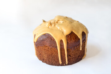 Delicious Easter Kulich cake with milk filling and raisins and candied fruit isolated on white background