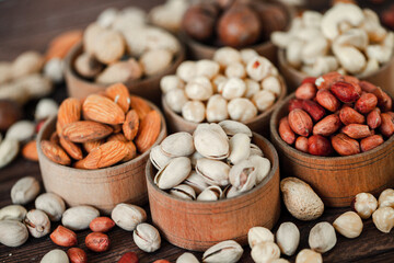 Assorted nuts for a background Almond, walnut,cashew, pistachios, hazelnuts, peanuts, Macadamia Collection of different varieties of nuts. Composition with dried fruits Healthy food. Organic