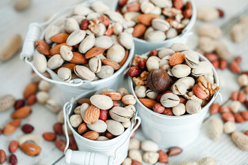 Assorted nuts for a background Almond, walnut,cashew, pistachios, hazelnuts, peanuts, Macadamia Collection of different varieties of nuts. Composition with dried fruits Healthy food. Organic