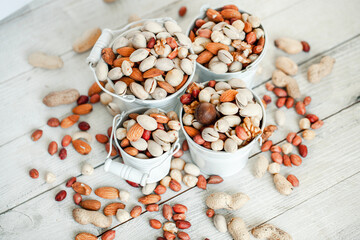 Assorted nuts for a background Almond, walnut,cashew, pistachios, hazelnuts, peanuts, Macadamia Collection of different varieties of nuts. Composition with dried fruits Healthy food. Organic
