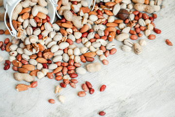 Assorted nuts for a background Almond, walnut,cashew, pistachios, hazelnuts, peanuts, Macadamia Collection of different varieties of nuts. Composition with dried fruits Healthy food. Organic