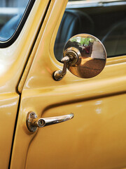 Vintage car detaill. Window and rear mirror.