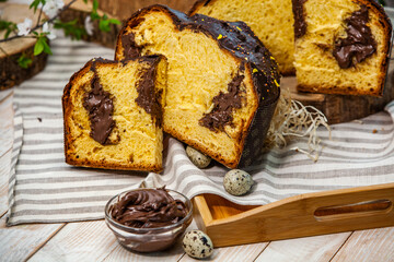 Panettone is the traditional Italian dessert for easter in 2021. Homemade panettone covered in chocolate and sprinkles. Bread served as dessert.