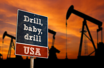 Drill, baby, drill slogan with oil industry pumps in background