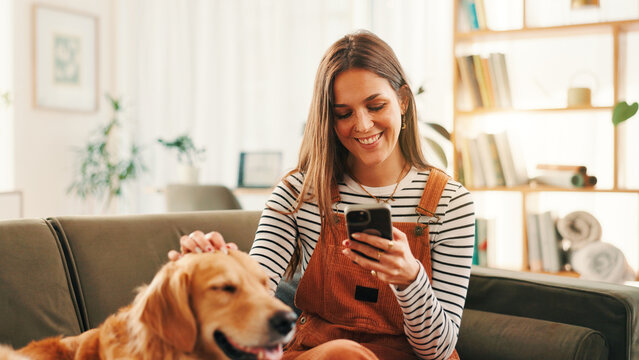 Phone, relax and woman on sofa with dog for bonding, reading or social media scroll at home on day off. Smartphone, smile and female person in living room with golden retriever, love and search