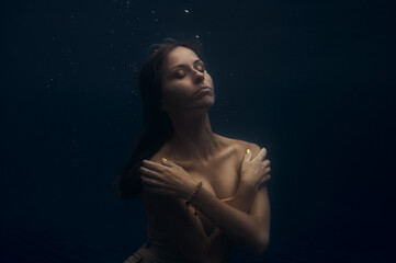 Elegant Woman Floating Underwater in Peaceful and Serene Environment..
