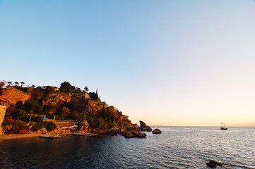 Rocky Coastal Landscape at Sunset with a Calm Ocean..