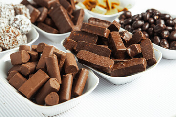 Assortment of sweet confectionery with chocolate candies and pralines. Children's holiday table with chocolate sweets