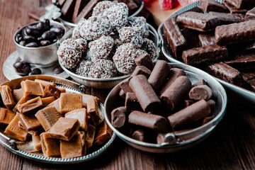 Assortment of sweet confectionery with chocolate candies and pralines. Children's holiday table with chocolate sweets