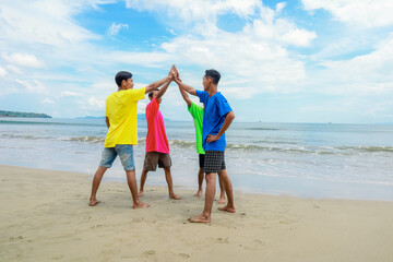 Four Friends Celebrate On Sunny Beach In Colorful Shirts