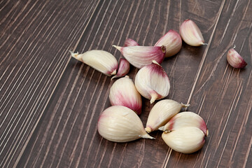 Fresh Garlic Bulb with Peeling Skins. purple garlic.  Suitable for cooking, health, food introduction, nutrition topics.
