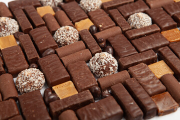Assortment of sweet confectionery with chocolate candies and pralines. Children's holiday table with chocolate sweets