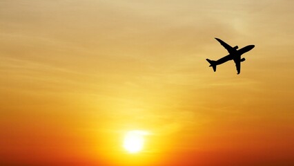 Taking Flight at Sunset: A solitary airplane soars through a vibrant sunset sky, silhouetted against a fiery orange backdrop. The image evokes a sense of freedom and adventure.
