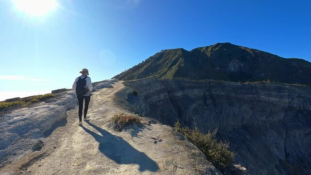 Tourist walking on mount bromo crater rim in indonesia