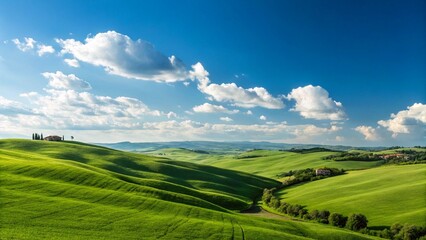 This image captures a serene vista of lush green rolling hills extending into the distance under a clear blue sky dotted with fluffy white clouds, evoking a sense of peaceful nature