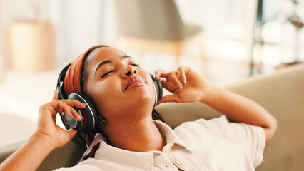 Relax, happy woman and listening to music in living room with podcast, audiobook or sound. African...