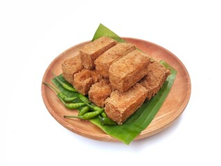 Tahu Sumedang on wooden plate or Asian food made from the sediment of coagulated soybeans. Isolated...