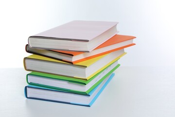 Stack of colorful books on white background