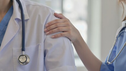 A healthcare professional with a stethoscope consoling a patient.
