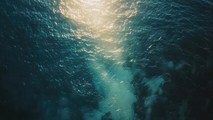 Aerial View of Sparkling Ocean Waves Under Bright Sunlight