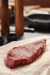 closeup raw seasoned new york steak on concrete countertop background