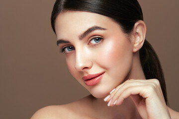 Portrait beautiful young woman with clean fresh skin. Model with healthy skin looks at an empty...