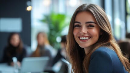 Fototapeta premium Smiling young woman enjoying a productive work environment with colleagues in an office setting during daytime