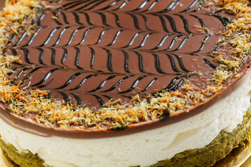 chocolate pistachio cake in a white cardboard box